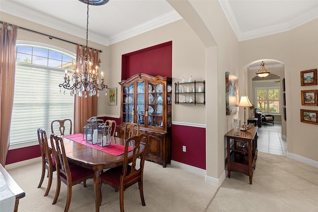 133 Torino Ln, Kissimmee, FL 34759 - dining area featuring arched walkways, ornamental molding, a chandelier, and light tile patterned floors