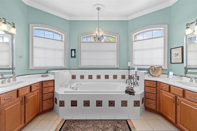 133 Torino Ln, Kissimmee, FL 34759 - full bath with tile patterned flooring, two vanities, a chandelier, a bath, and crown molding