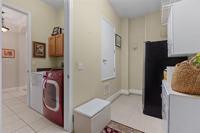 133 Torino Ln, Kissimmee, FL 34759 - laundry room with cabinet space, washing machine and clothes dryer, and light tile patterned floors