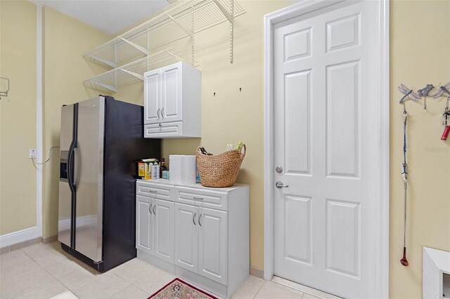 133 Torino Ln, Kissimmee, FL 34759 - kitchen featuring fridge with ice dispenser, white cabinets, light tile patterned flooring, and light countertops