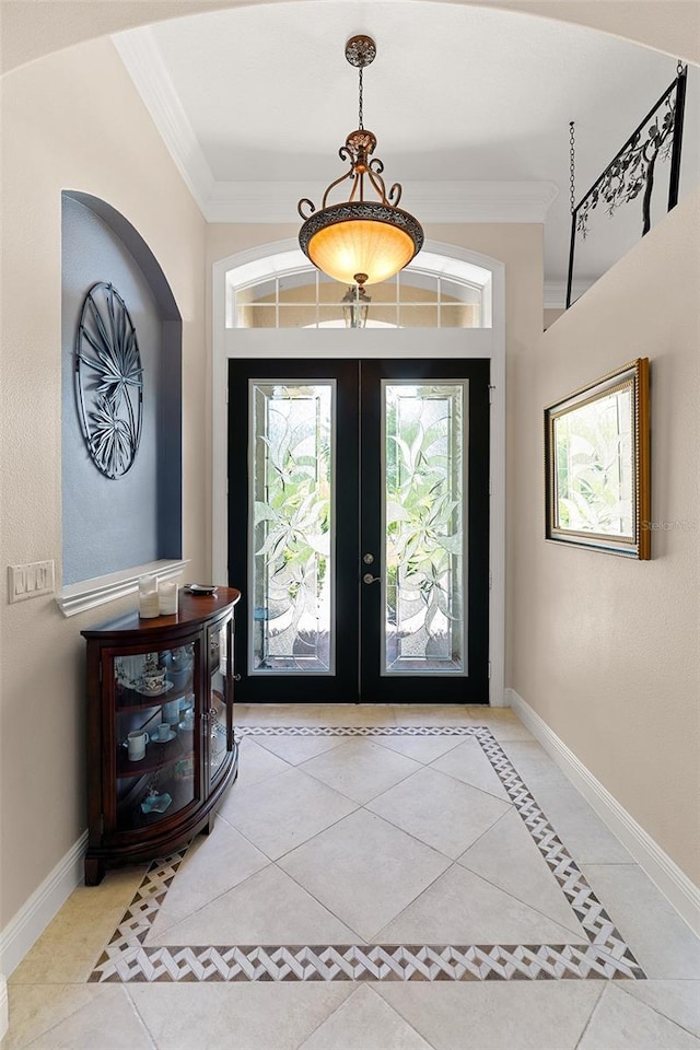 133 Torino Ln, Kissimmee, FL 34759 - foyer entrance featuring crown molding, tile patterned flooring, french doors, and healthy amount of natural light