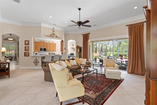 133 Torino Ln, Kissimmee, FL 34759 - living area featuring arched walkways, a ceiling fan, light tile patterned flooring, ornamental molding, and recessed lighting