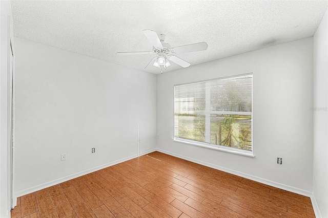 1560 Vista Lake Cir, Melbourne, FL 32904 - unfurnished room featuring baseboards, a ceiling fan, wood finished floors, and a textured ceiling