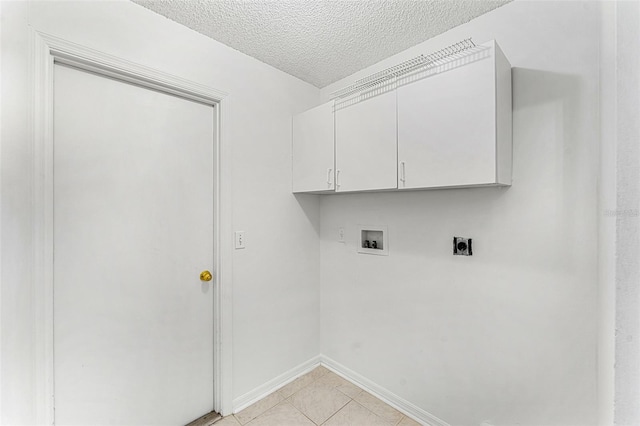 1560 Vista Lake Cir, Melbourne, FL 32904 - clothes washing area with light tile patterned floors, washer hookup, a textured ceiling, hookup for an electric dryer, and cabinet space