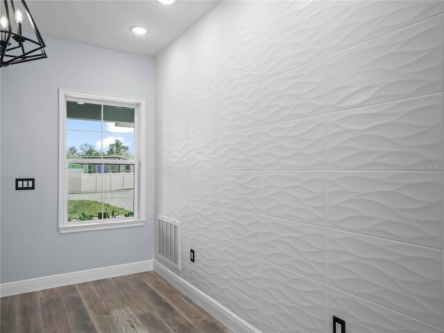 145 Willow Dr, Poinciana, FL 34759 - empty room with visible vents, baseboards, a notable chandelier, recessed lighting, and dark wood-type flooring