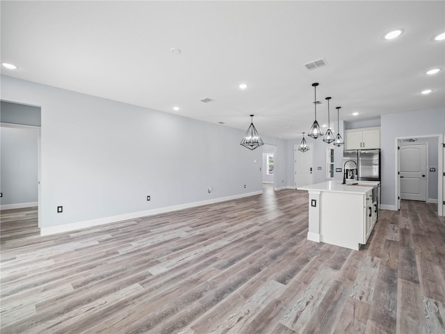 145 Willow Dr, Poinciana, FL 34759 - kitchen featuring a chandelier, recessed lighting, open floor plan, and visible vents