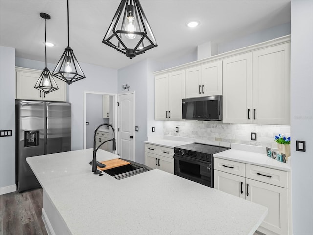 145 Willow Dr, Poinciana, FL 34759 - kitchen featuring tasteful backsplash, a sink, light countertops, a kitchen island with sink, and black appliances