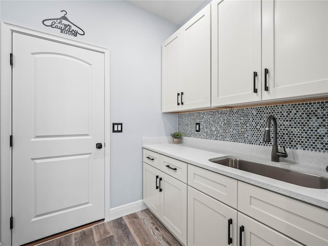 145 Willow Dr, Poinciana, FL 34759 - interior space with a sink, tasteful backsplash, white cabinets, and dark wood finished floors