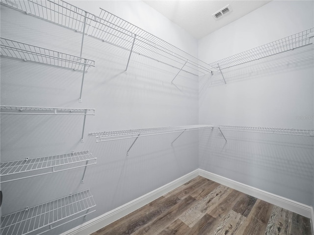 145 Willow Dr, Poinciana, FL 34759 - spacious closet featuring wood finished floors and visible vents