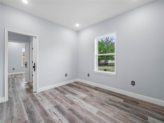 145 Willow Dr, Poinciana, FL 34759 - empty room with wood finished floors, baseboards, and recessed lighting