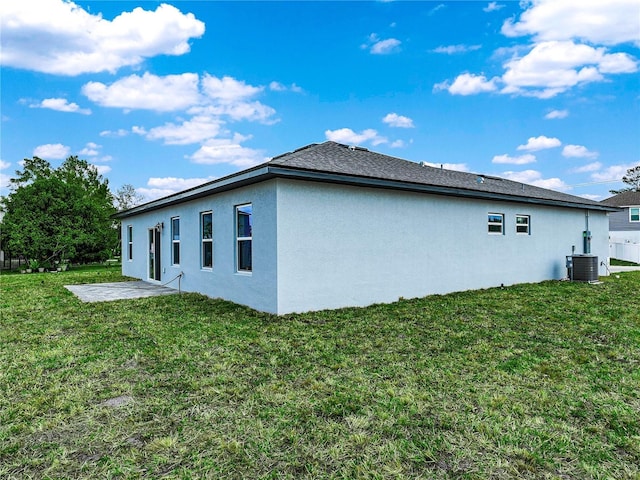 145 Willow Dr, Poinciana, FL 34759 - view of home's exterior featuring cooling unit, a patio, a yard, and stucco siding