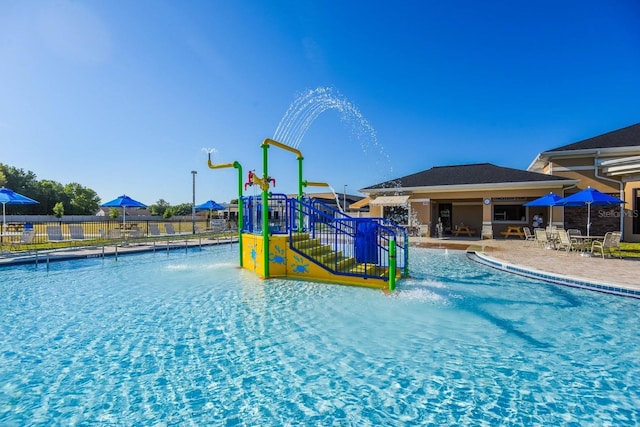 145 Willow Dr, Poinciana, FL 34759 - view of swimming pool featuring a patio area, fence, and playground community
