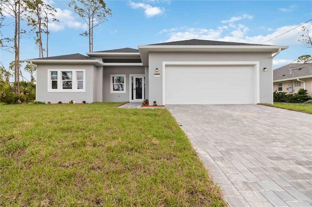 view of front facade featuring an attached garage, stucco siding, a front yard, and decorative driveway