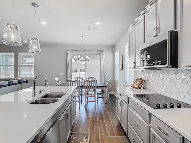 kitchen featuring visible vents, a sink, appliances with stainless steel finishes, and a healthy amount of sunlight