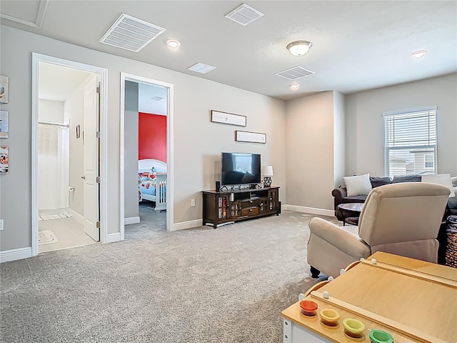 carpeted living room featuring baseboards and visible vents