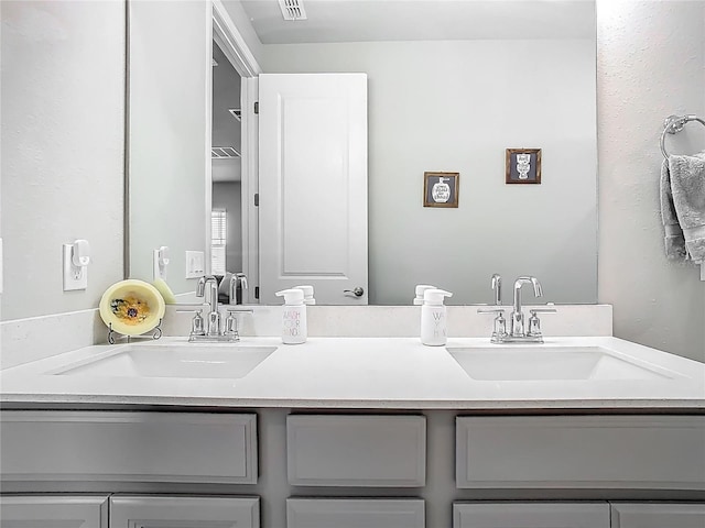 full bathroom featuring visible vents, a sink, and double vanity