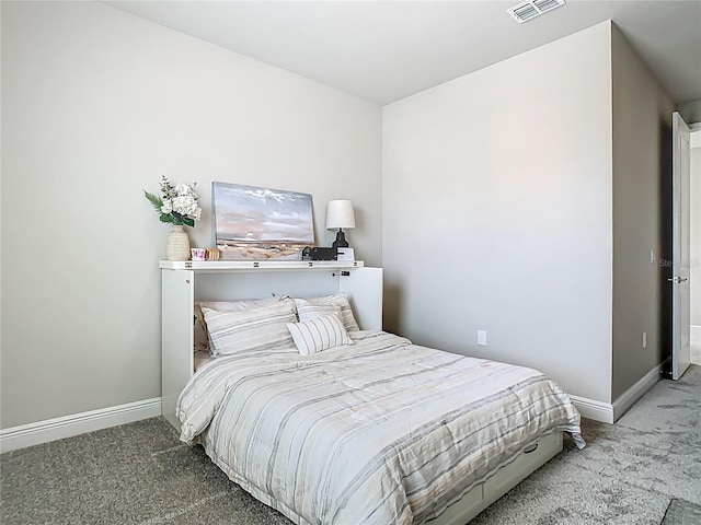 carpeted bedroom featuring visible vents and baseboards