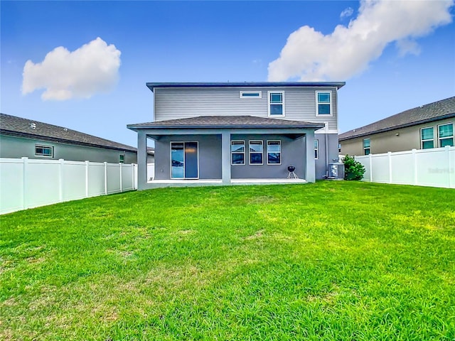 back of property featuring a lawn, a fenced backyard, and central air condition unit