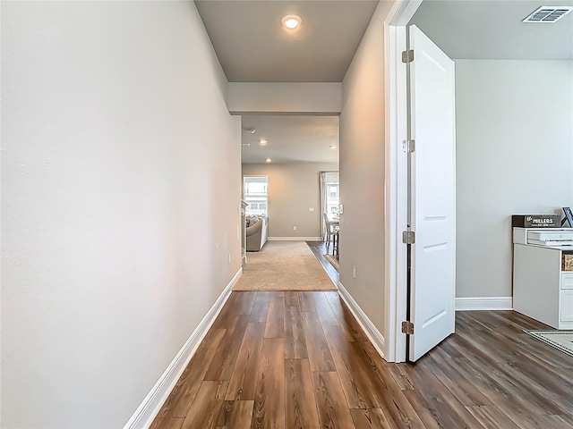corridor with recessed lighting, baseboards, visible vents, and dark wood-style floors