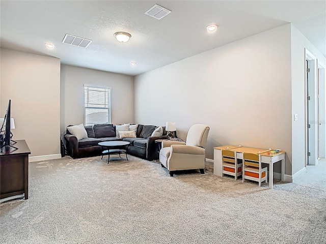 living room featuring carpet, visible vents, and baseboards