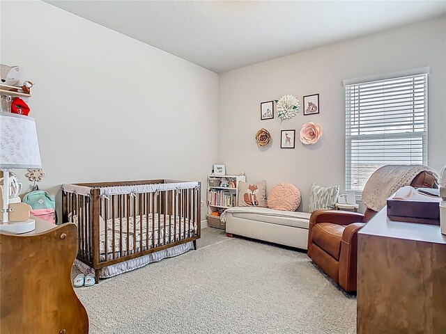 carpeted bedroom with a crib