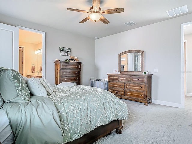 carpeted bedroom featuring visible vents, baseboards, ceiling fan, and connected bathroom