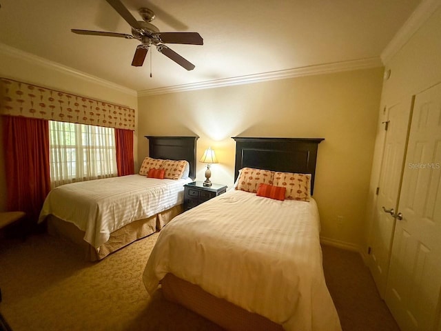 carpeted bedroom with ornamental molding, baseboards, and a ceiling fan