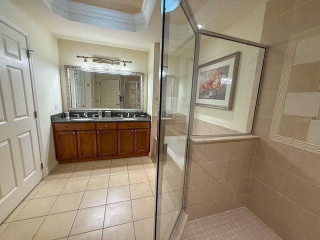 bathroom featuring double vanity, a stall shower, tile patterned floors, crown molding, and a sink