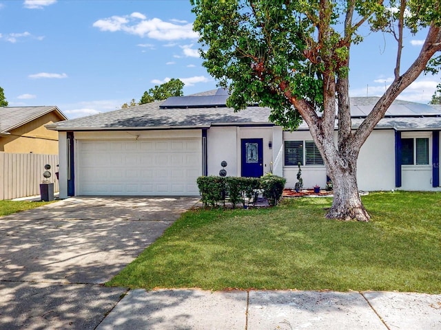 5123 Lighthouse Rd, Orlando, FL 32808 - view of front of property with a garage, concrete driveway, roof mounted solar panels, and stucco siding