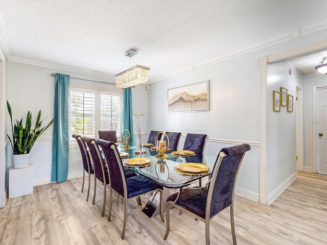 5123 Lighthouse Rd, Orlando, FL 32808 - dining area featuring wood finished floors, a textured ceiling, crown molding, and baseboards