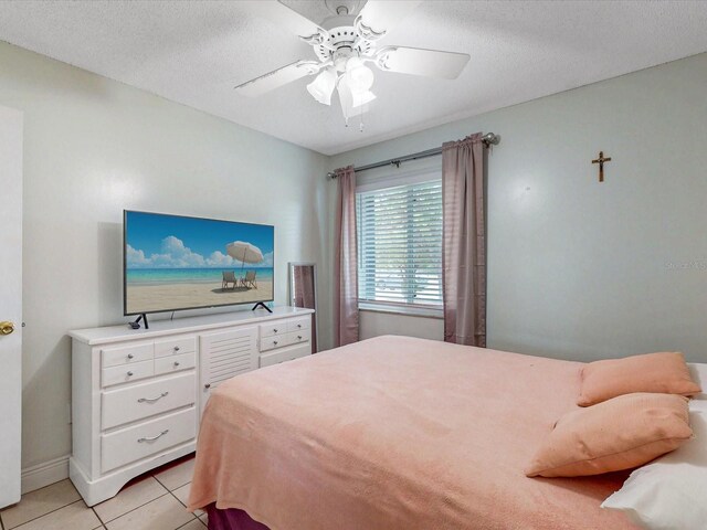 5123 Lighthouse Rd, Orlando, FL 32808 - bedroom featuring light tile patterned floors, a ceiling fan, and a textured ceiling