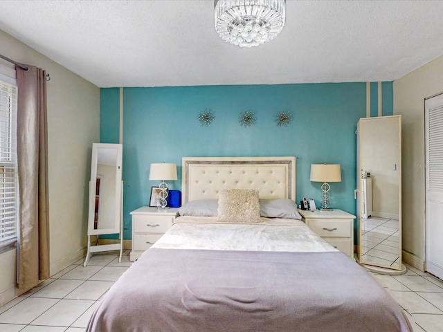 5123 Lighthouse Rd, Orlando, FL 32808 - bedroom with light tile patterned floors, a chandelier, and baseboards