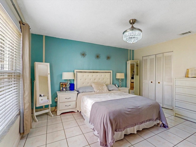 5123 Lighthouse Rd, Orlando, FL 32808 - bedroom featuring light tile patterned floors, a closet, and a chandelier