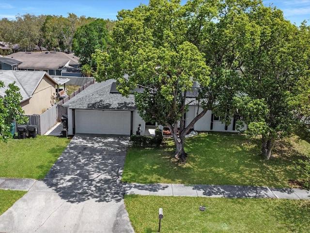 5123 Lighthouse Rd, Orlando, FL 32808 - view of front of home with an attached garage, concrete driveway, stucco siding, and roof mounted solar panels