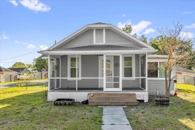 503 New York Ave, Saint Cloud, FL 34769 - bungalow-style home featuring a front yard, roof with shingles, and a sunroom