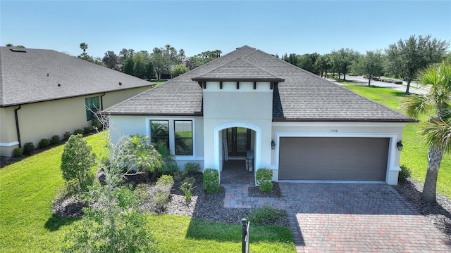 1948 Molise Dr, Kissimmee, FL 34759 - french country inspired facade featuring a garage, a shingled roof, a front yard, and stucco siding