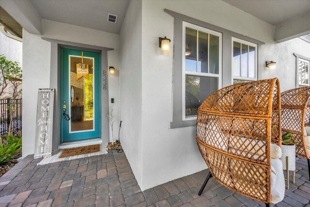 8338 Modiano St, Orlando, FL 32827 - doorway to property with visible vents and stucco siding
