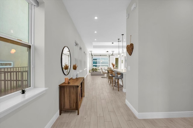 8338 Modiano St, Orlando, FL 32827 - hallway featuring baseboards, recessed lighting, and light wood-style flooring
