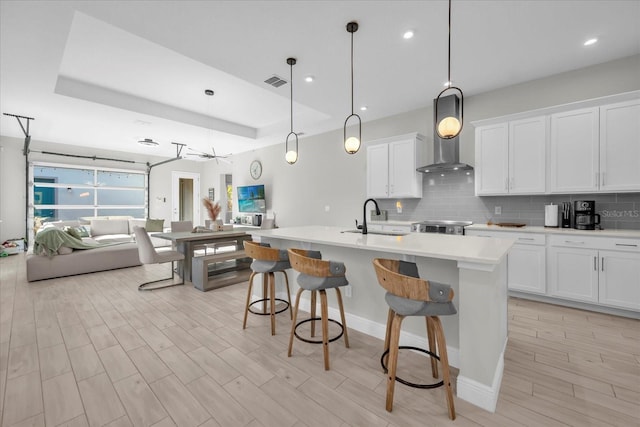 8338 Modiano St, Orlando, FL 32827 - kitchen featuring backsplash, visible vents, a sink, light countertops, and open floor plan