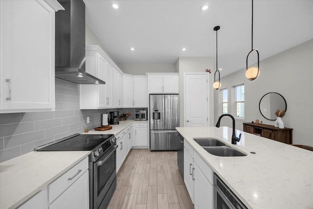 8338 Modiano St, Orlando, FL 32827 - kitchen featuring decorative backsplash, wall chimney exhaust hood, white cabinets, a sink, and appliances with stainless steel finishes