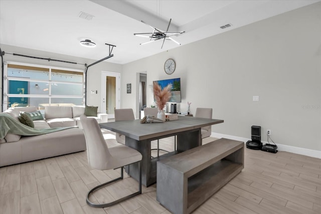 8338 Modiano St, Orlando, FL 32827 - dining space featuring visible vents, light wood finished floors, and baseboards