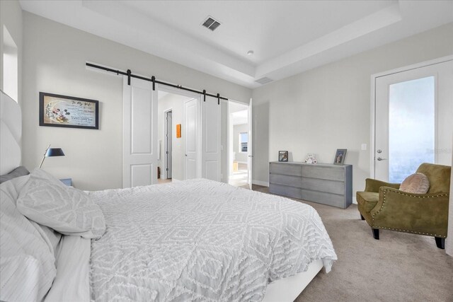 8338 Modiano St, Orlando, FL 32827 - bedroom featuring carpet floors, a tray ceiling, visible vents, and a barn door