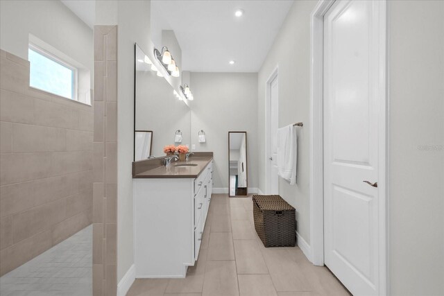 8338 Modiano St, Orlando, FL 32827 - bathroom featuring a walk in shower, baseboards, vanity, tile patterned floors, and recessed lighting