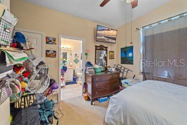 18011 Prairie Wolf Gln, Parrish, FL 34219 - carpeted bedroom featuring ceiling fan and vaulted ceiling