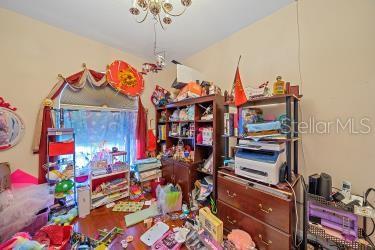 18011 Prairie Wolf Gln, Parrish, FL 34219 - office with a notable chandelier