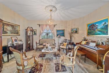 18011 Prairie Wolf Gln, Parrish, FL 34219 - living area featuring a notable chandelier