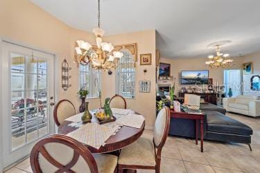 18011 Prairie Wolf Gln, Parrish, FL 34219 - dining space featuring a chandelier and light tile patterned floors