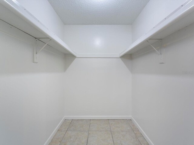 12513 Indiana Woods Ln, Orlando, FL 32824 - spacious closet featuring light tile patterned flooring