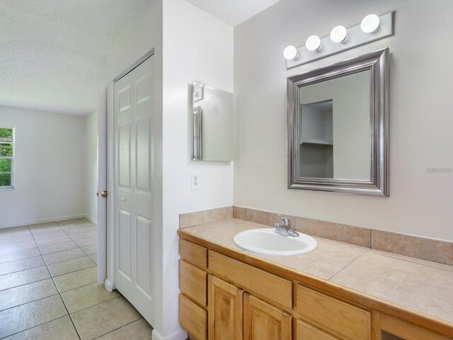 12513 Indiana Woods Ln, Orlando, FL 32824 - bathroom with vanity, tile patterned floors, and a textured ceiling
