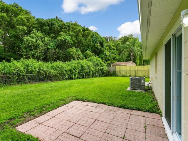 12513 Indiana Woods Ln, Orlando, FL 32824 - view of yard featuring a patio area and central air condition unit
